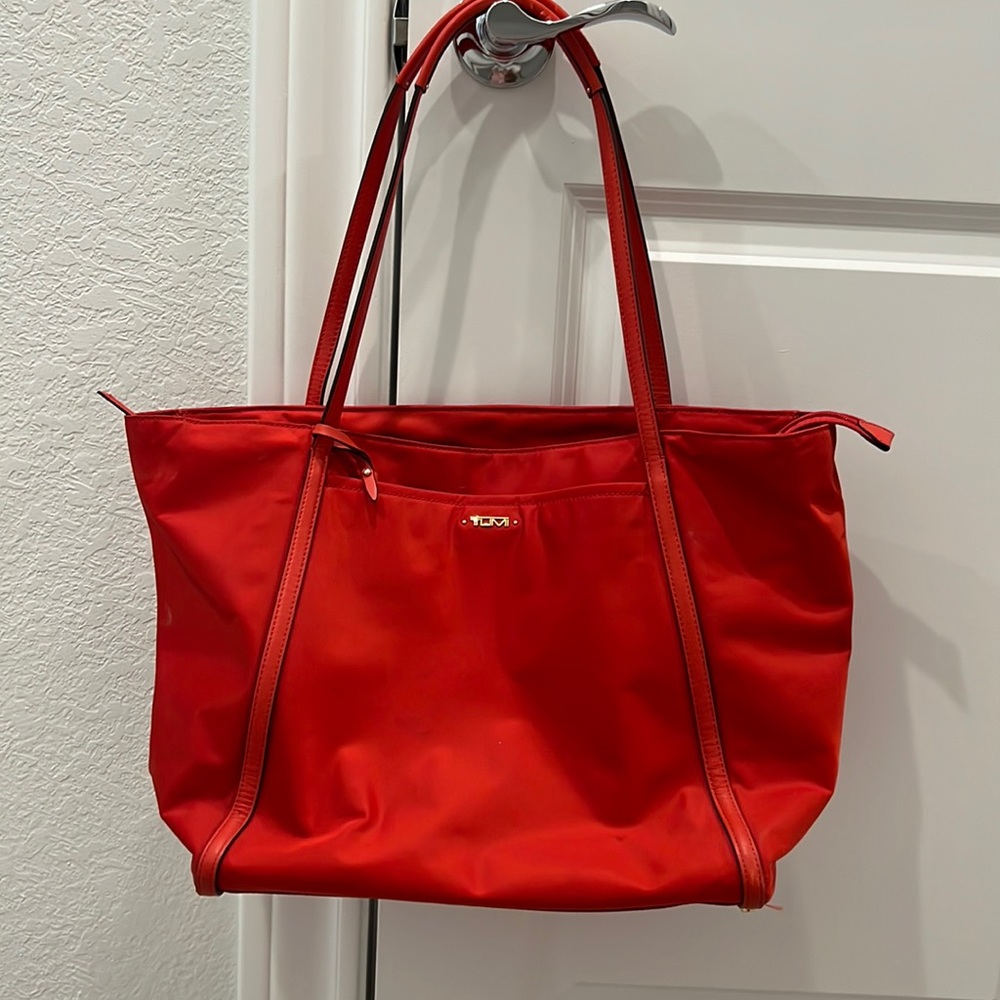 Orange Tumi vinyl bag